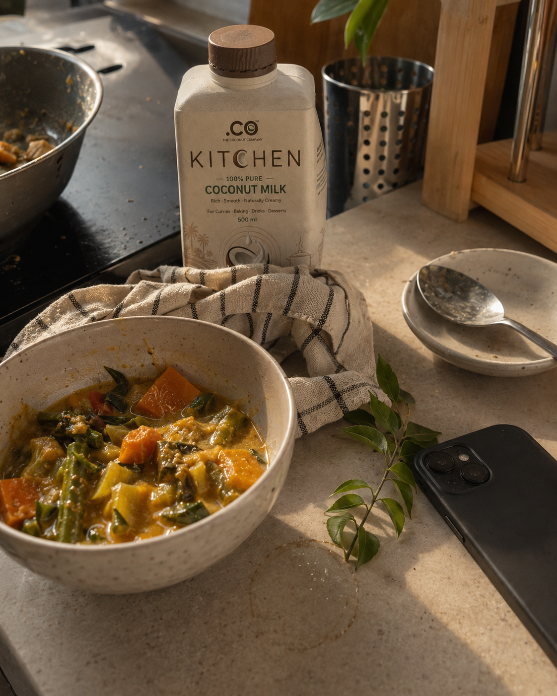 .CO coconut milk beside a freshly cooked meal